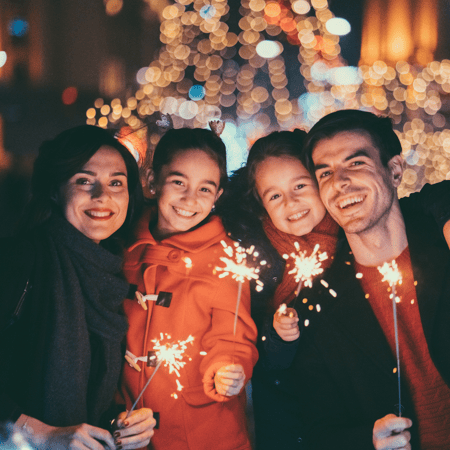 A family celebrating new years with sparklers.