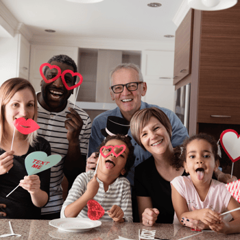 A family playing with Valentines themed props.