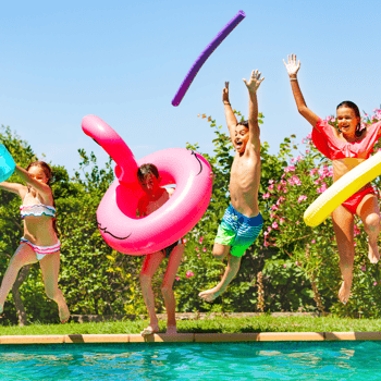 Kids jumping into a pool with floaties.
