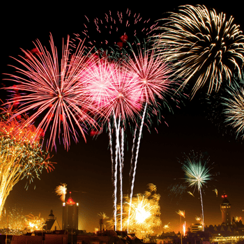 Fireworks in the sky over a city.