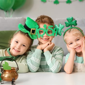 Kids in St. Patricks Day headbands and glasses.