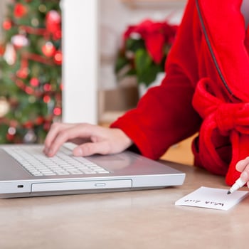 A lady making a list of things online.