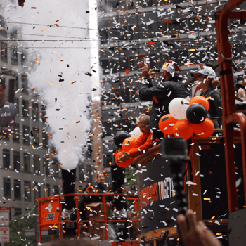 Confetti flying during a parade.