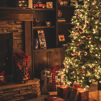 A Christmas tree with presents under it.