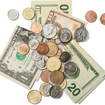 Coins and dollar bills on a white backdrop.