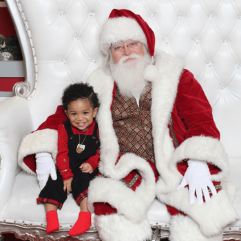 Baby boy smiling with Santa.