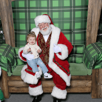 Baby girl smiling with Santa.