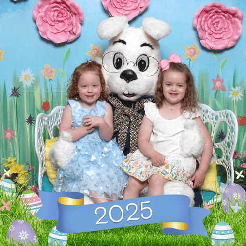 2 sisters wearing pastel dresses and posting with the Bunny