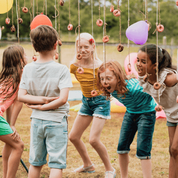 Kids eating donuts on a string.