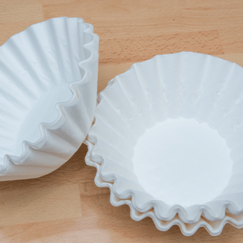 White coffee filters on a table.