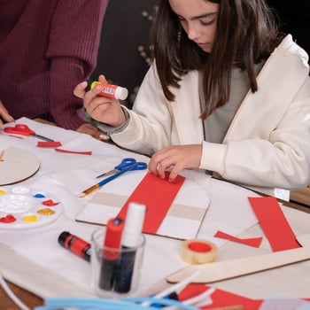 A girl doing a valentine craft.
