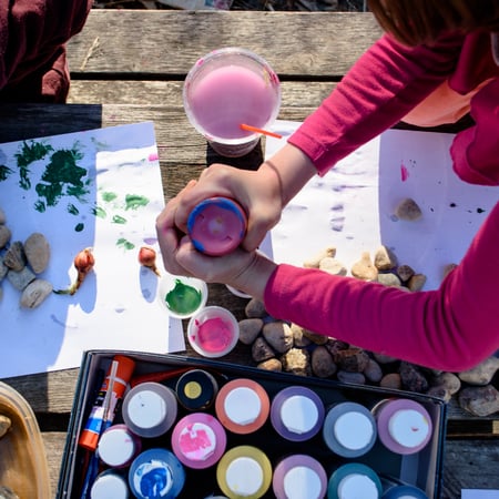 Kids painting rocks outside