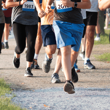 Runners with number tags running.