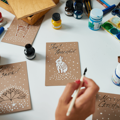 A homemade Christmas card with a white bunny and snow that says "Joy!"