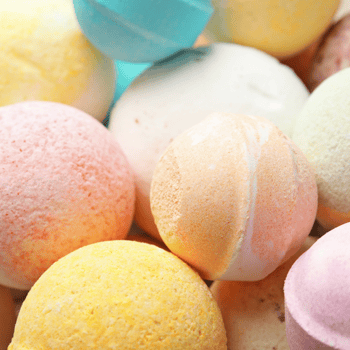 Colorful bath bombs of assorted sizes.