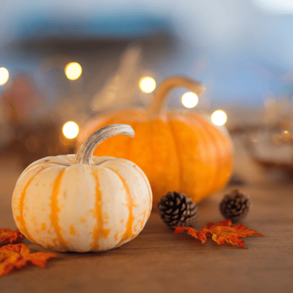 Small pumpkins and acorns on a table.