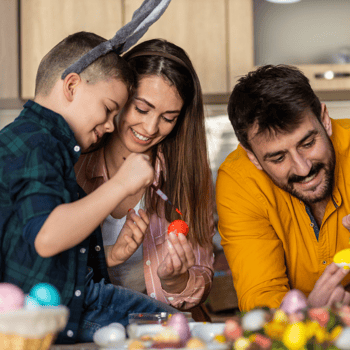 A family painting Easter Eggs together.