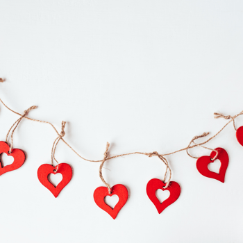 Red hearts on a piece of twine to make a garland.