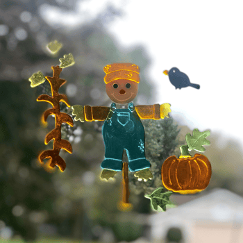A fall themed window cling set with a scarecrow and pumpkin.