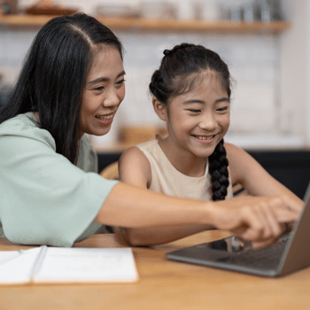A mom helping her daughter with homework.