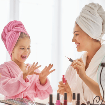 A little girl having a spa day with her mom.