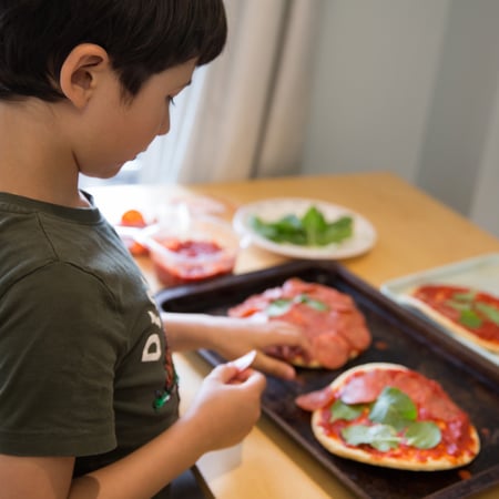 Boy making homemade pizza
