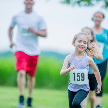 A little girl with her family running.