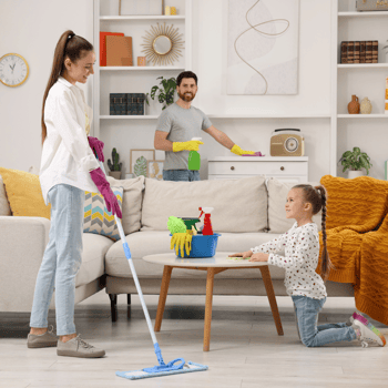 A family cleaning a living room together.