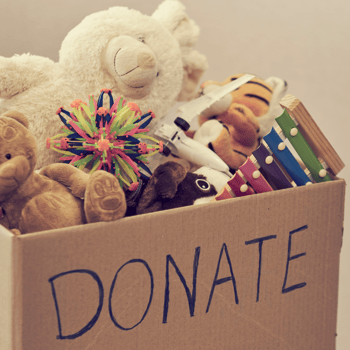 A box full of toys that says "Donate" on the side.