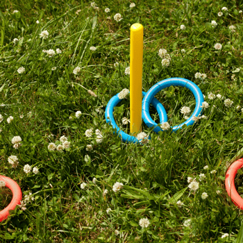 A game of ring toss in summer grass.