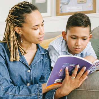 A mom and her son reading a book together.