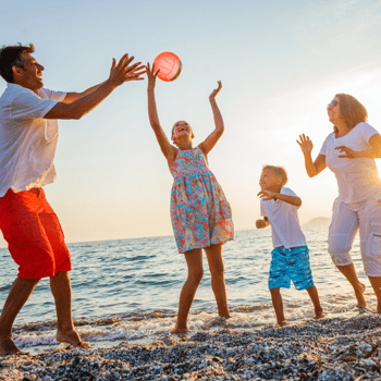 A family playing beach volleyball.