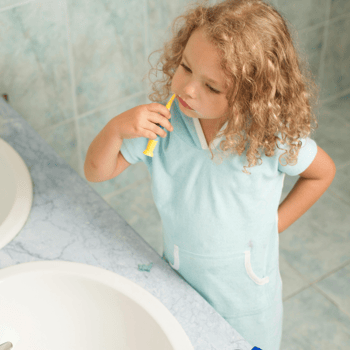A little girl brushing her teeth.