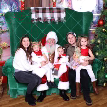 A family sitting with Santa.