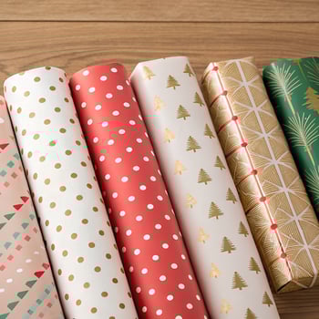 Multiple rolls of Christmas wrapping paper.