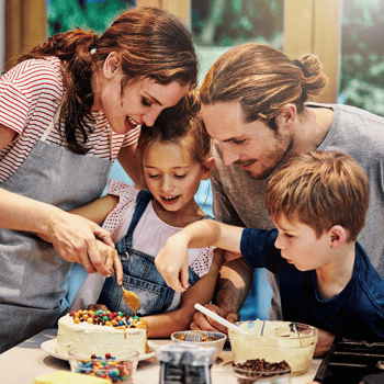 A family baking a cake together.