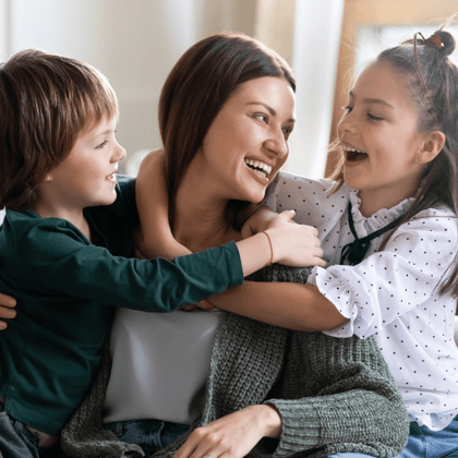 A mom with her kids laughing.