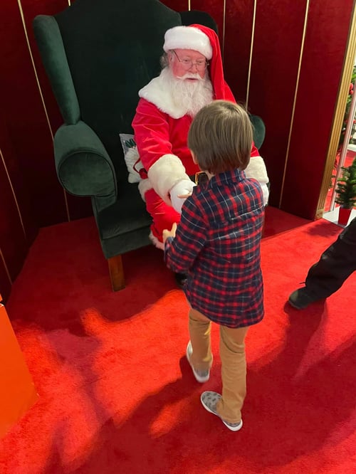 Autistic boy meets Santa and gives him a high five
