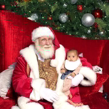 Baby sitting in Santa's lap.