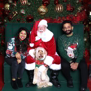 A family with their dog and Santa.
