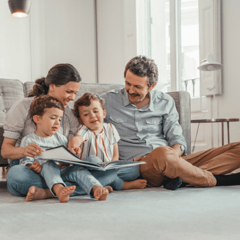 A family reading in the living room together.