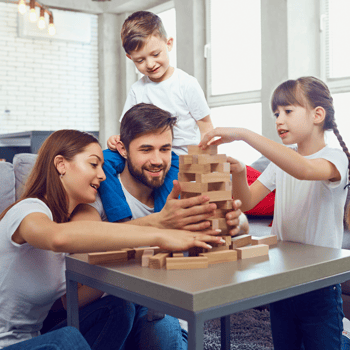 A family playing a game of Jenga together.
