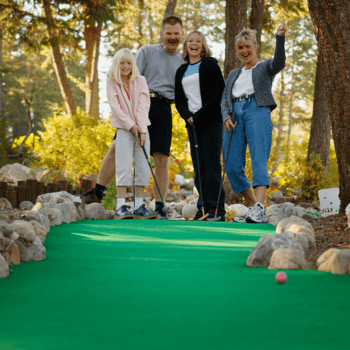 A family doing mini golf together.
