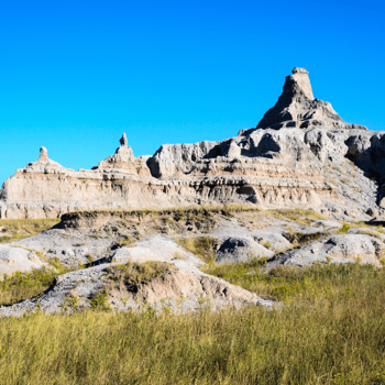 Rocky canyons surrounded by green grass.