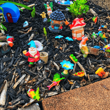 Fairy figurines in a fairy garden.