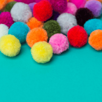 Assorted color craft pom poms.