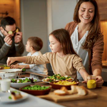 A family cooking in the kitchen together.