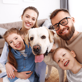 A family being happy together with their dog.