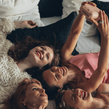A group of friends taking a polaroid photo.