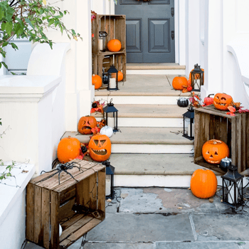 Carved pumpkins displayed on a porch.